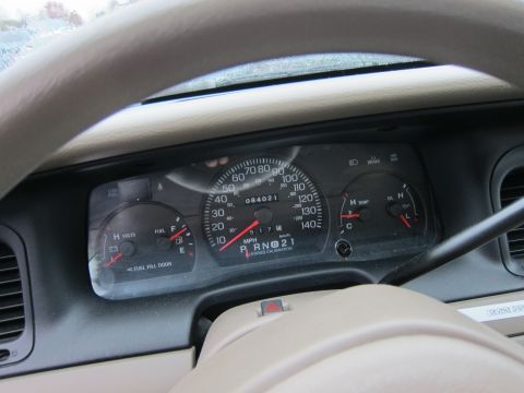 2001 Ford Crown Victoria - The interior dashboard of a 2001 Ford Crown Victoria displays its speedometer, fuel gauge, and temperature gauge.