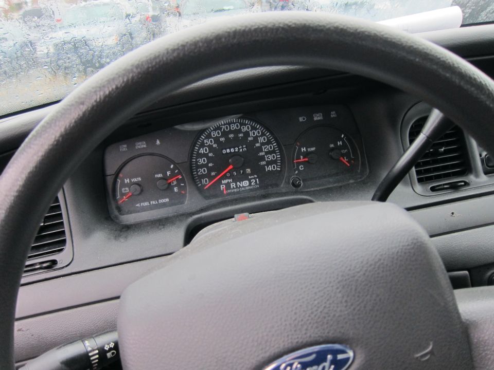Dashboard of a 2001 Ford Crown Victoria showing speedometer, fuel gauge, temp gauge, and odometer