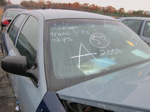 2001 Ford Crown Victoria - Chalk markings on the windshield of a light blue sedan indicate a 2006 model year, contradicting the registry's claim.