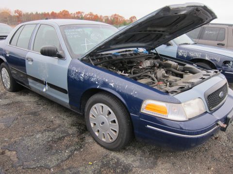 2001 Ford Crown Victoria - This 2001 Ford Crown Victoria has a two-tone paint job and the hood is open, revealing the engine compartment.