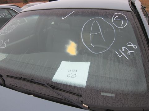 2001 Ford Crown Victoria - Windshield interior view with inspection markings and an item tag, another vehicle in background.