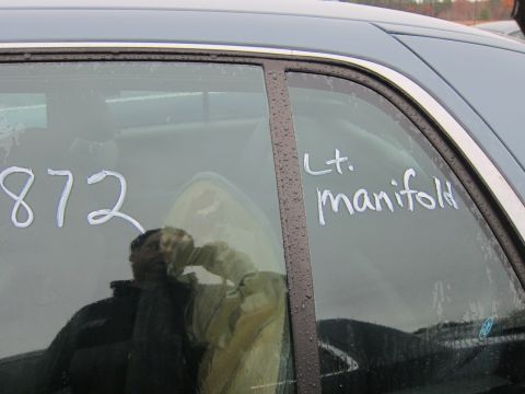 2001 Ford Crown Victoria - White markings on a car window include the number 872 and the text 'Lt. manifold'.