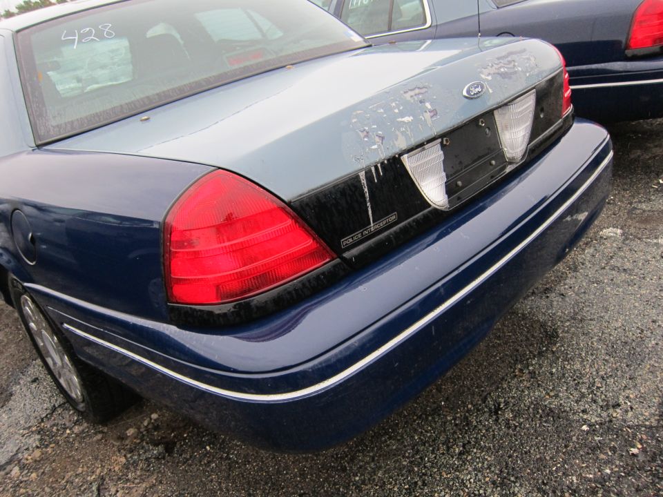 Rear of a blue 2001 Ford Crown Victoria Police Interceptor with a faded light blue trunk lid