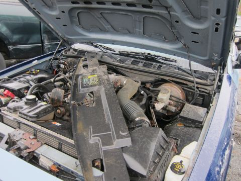 2001 Ford Crown Victoria - Engine bay of a 2001 Ford Crown Victoria, with the hood up and a large plastic air intake shroud removed.