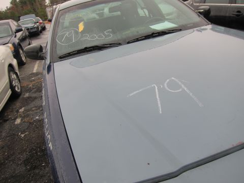 2001 Ford Crown Victoria - Chalk markings on the hood and windshield of a blue sedan, with other vehicles visible in the background.