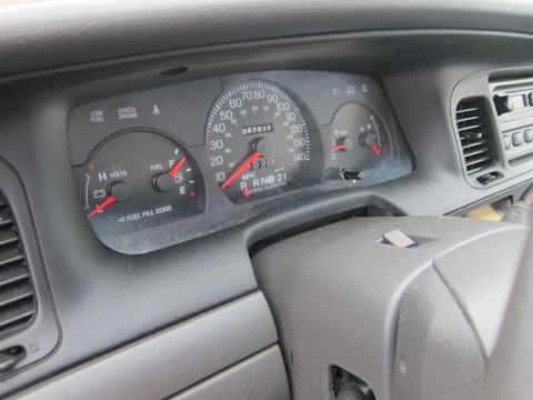 2001 Ford Crown Victoria - Dashboard view of a 2001 Ford Crown Victoria, showing the instrument cluster and steering column.