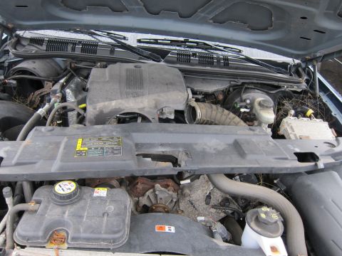 2001 Ford Crown Victoria - The engine bay of a 2001 Ford Crown Victoria, showing the coolant reservoir, air intake, and other engine components.