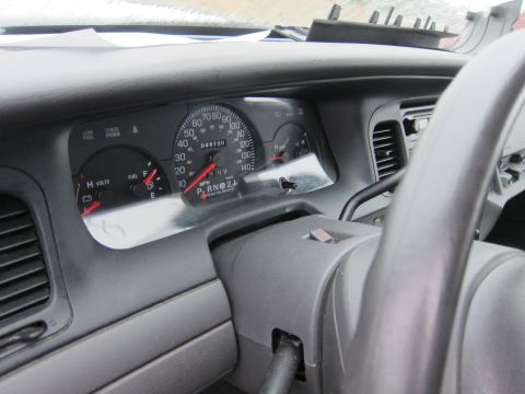 2001 Ford Crown Victoria - Interior view of a 2001 Ford Crown Victoria, focusing on the dashboard and steering column.