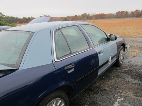 2001 Ford Crown Victoria - This 2001 Ford Crown Victoria is seen from the front-three-quarter angle with its hood ajar.