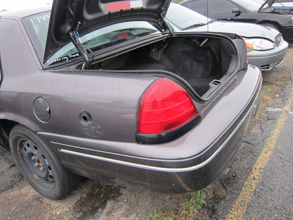 Gray sedan's open trunk and rear quarter panel. Text 'Steering Done' visible inside trunk