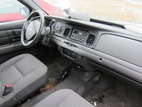 2001 Ford Crown Victoria - The interior of a 2001 Ford Crown Victoria shows the driver's side dashboard and front seats.