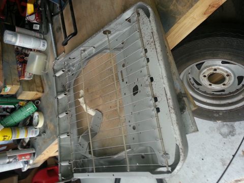 1994 Ford Bronco - A disassembled seat frame is shown, with springs and metal supports visible.