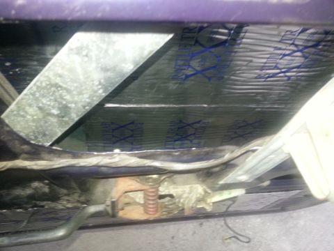 1994 Ford Bronco - Vehicle floor pan and frame from below showing Rattletrap reflective sound-deadening insulation, brake lines and exhaust.