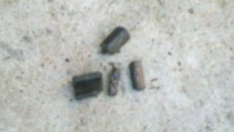 1997 Dodge 3500 - Several small automotive parts are visible on a concrete surface.