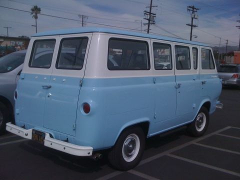 1968 Ford Mustang - This light blue and white Ford Econoline van is seen from the rear in a parking lot.