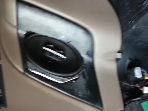 1994 Ford Bronco - The photo shows a car door speaker and its surrounding trim panel.