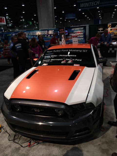 2013 Ford Mustang - This 2013 Ford Mustang GT features a striking orange and white custom hood wrap.