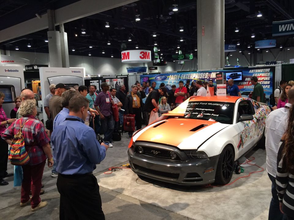 Customized 2013 Ford Mustang GT, orange and white with graphics, 3q-front view