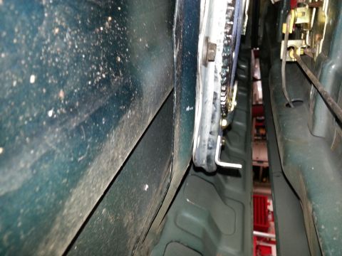1994 Ford Bronco - Photograph of a vehicle door latch and hinge area, not a technical document.