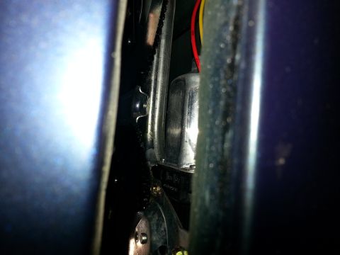 1994 Ford Bronco - Photograph of a vehicle door hinge and wiring, not a technical document.