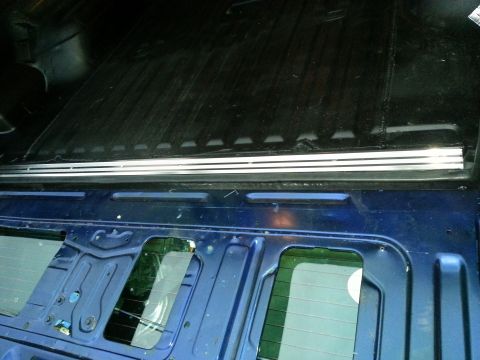 1994 Ford Bronco - Photograph of a truck bed rail and body panel, not a technical document.