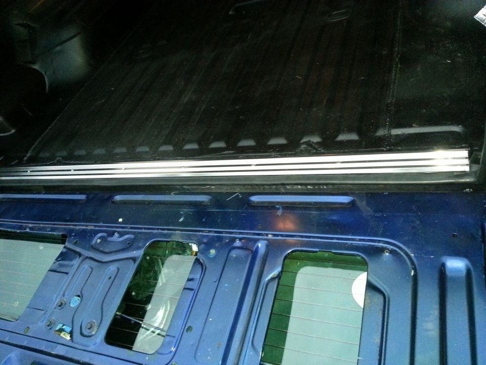 View of a truck bed rail and inner tailgate or body panel