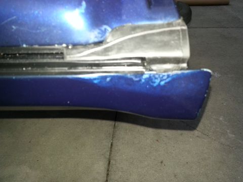 1994 Ford Bronco - Photograph of a blue body panel with a welded repair section, not a technical document.