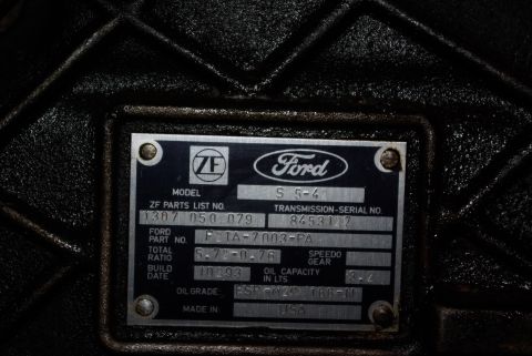 1995 Ford Bronco - A close-up shot of a metal data plate on a vehicle transmission. The plate displays the Ford logo and a ZF logo, along with various part nu…