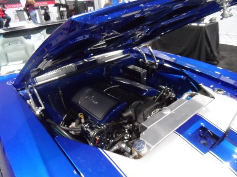 1971 Ford Ranchero - The open hood of a custom blue 1971 Ford Ranchero reveals a polished engine bay with a V8 engine and aluminum radiator.