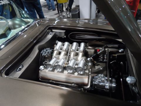 1971 Ford Ranchero - The engine bay of a custom vehicle, likely a classic pickup or muscle car, is shown with a polished V8 engine featuring individual throttle…
