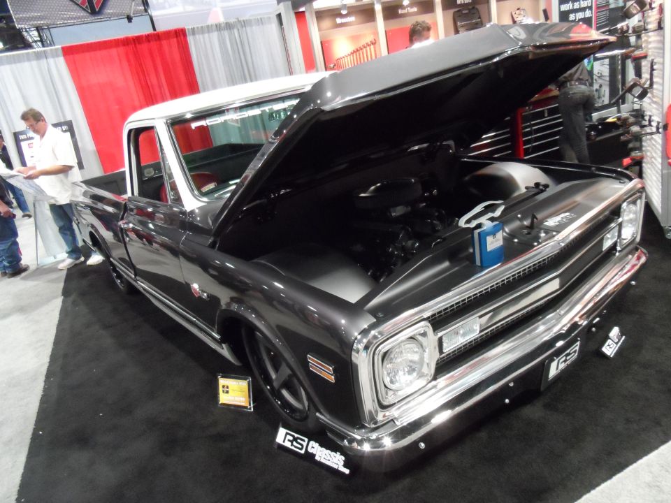 1971 Ford Ranchero pickup truck with hood open, showing engine, on display