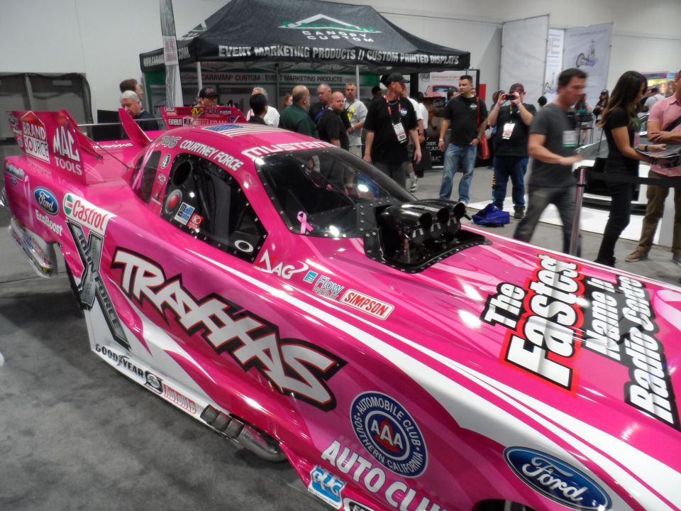 Pink drag racing car with TRAXXAS and The Fastest Name In Radio Control text