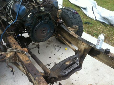 1979 Ford Bronco - The chassis and engine of a vehicle are visible, undergoing some form of maintenance or assembly.