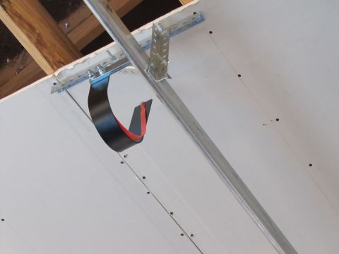 1995 Ford Bronco - This is a close-up, low-angle shot of a ceiling under construction. It shows drywall panels being attached to metal framing with screws. A…