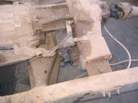1978 Ford Bronco - Close-up view of a vehicle's transfer case and associated linkage components.