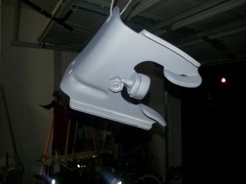 1994 Ford Bronco - A car part, possibly a fender or bracket, is suspended and coated in primer.