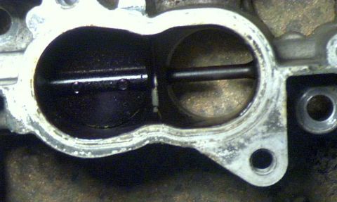 1997 Ford Taurus - Close-up view of a throttle body, a critical component in an engine's air intake system.