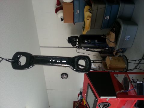 1994 Ford Bronco - A black tow hitch receiver is shown hanging in a workshop environment.