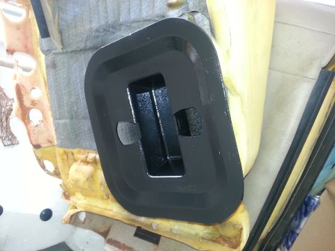 1994 Ford Bronco - A black plastic trim piece with a central cutout is shown, mounted on interior padding and insulation.