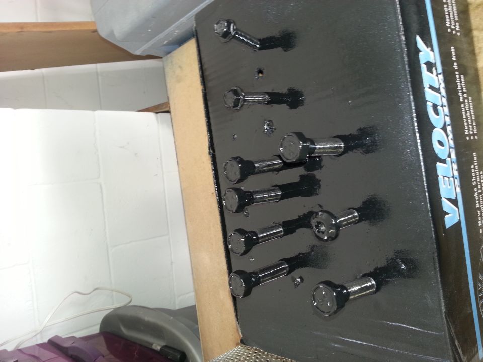 Box of Velocity brake shoes with bolts on a black backing board
