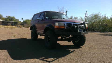 1996 Ford Bronco - This modified Ford Bronco is shown from a three-quarter front angle under a clear blue sky.
