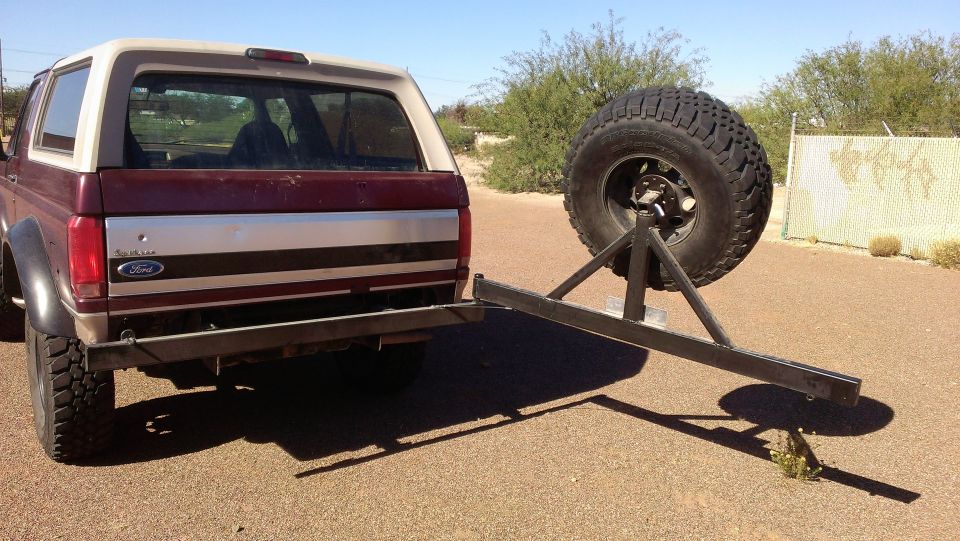 Rear view of a 1996 Ford Bronco with a custom spare tire carrier attached to the bumper