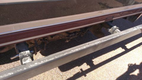 1996 Ford Bronco - Close-up view of the rear bumper and trailer hitch on a 1996 Ford Bronco, maroon body trim.