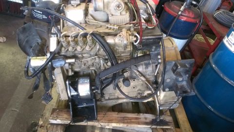 1996 Ford Bronco - Engine assembly shown on a pallet, with various hoses and electrical connections.