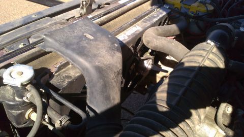 1996 Ford Bronco - Close-up view of the engine bay, showing various hoses and the air intake system.