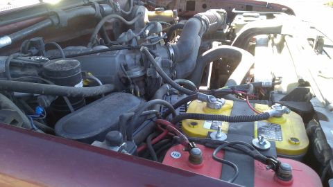 1996 Ford Bronco - Engine bay with dual batteries and V8 engine components visible.