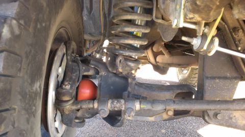 1996 Ford Bronco - Detailed view of the undercarriage and suspension system of a vehicle.