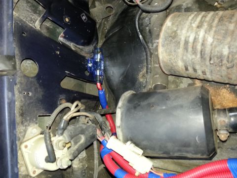 1994 Ford Bronco - This image shows a close-up view of a vehicle's electrical system, including wiring and a fuse box.