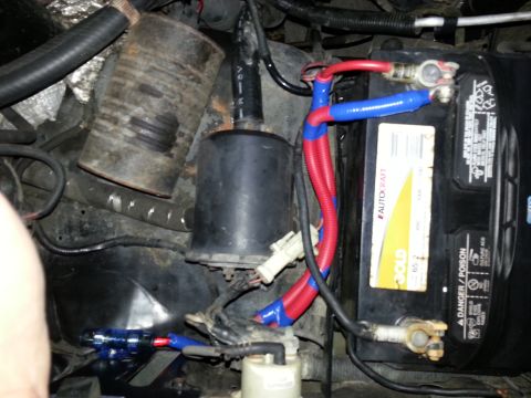 1994 Ford Bronco - Close-up of vehicle engine bay components, including battery and wiring, with visible SuperMotors.net watermark.