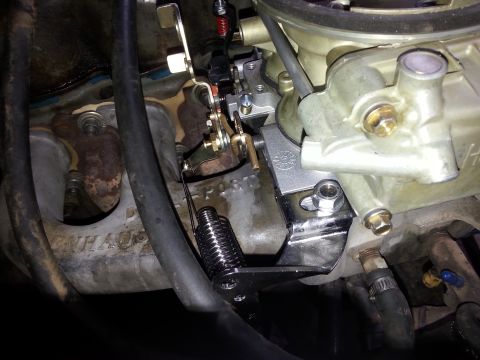 1981 Ford Bronco - A close-up view of engine components, including a carburetor and intake manifold, with visible hoses and linkages.